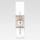 Traditional Japanese tea packaging with a white vase illustration on a light pink background