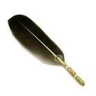 Feather quill pen with gold clip on a white background