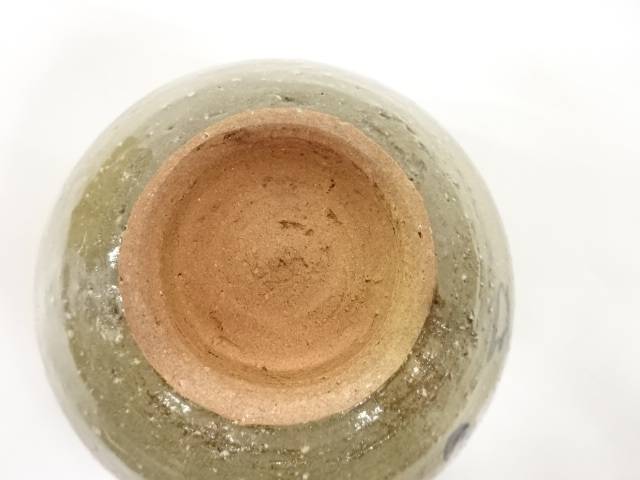 Underside view of the pre-owned matcha bowl showing the circular foot ring, exposed warm clay, and glaze surrounding the base.