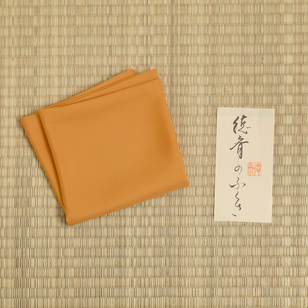 Orange silk fukusa with protective paper sleeve for Japanese Tea Ceremony