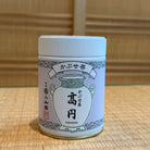 Tea canister with Japanese text and design on a wooden surface