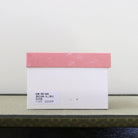 Pink and white presentation box for the Kagetsu Kiln Rikyu Shichisoku matcha bowl featuring Sen no Rikyu’s Seven Rules of Tea