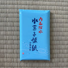 Blue package with text on a textured gray background