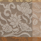 Close-up of the Kaka Karakusa-mon Donsu botanical arabesque and stone-paving pattern woven in Kyoto Nishijin silk for Chado, Sado and traditional tea ceremony.