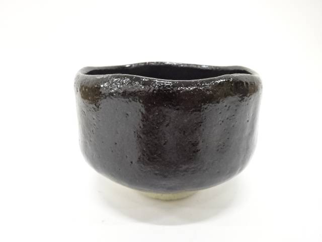 Front view of the pre-owned Kawasaki Waraku Black Raku matcha bowl with a rounded form and glossy black glaze.