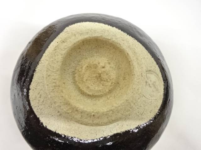 Underside view of the pre-owned Black Raku matcha bowl showing the unglazed foot and base.