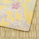 Angled view of a Japanese Nishijin silk kobukusa woven in rare silver brocade