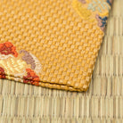 Angled view of a Japanese Nishijin silk kobukusa handcrafted for the tea ceremony