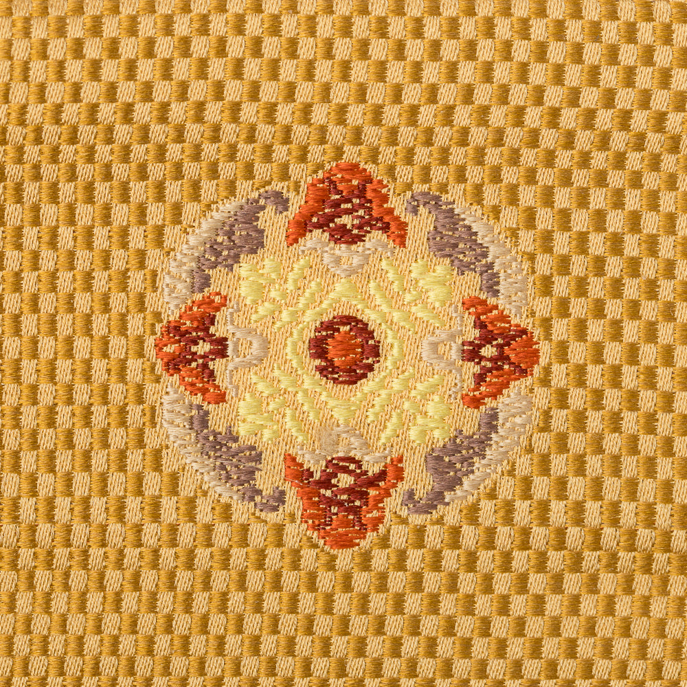 Close-up of an intricate floral motif woven into Kyoto Nishijin silk brocade
