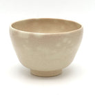 Back view of the matcha bowl showing its softly mottled ivory-beige glaze and rounded handcrafted form.