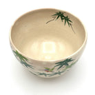 Top view of the kingfisher matcha bowl showing its warm beige interior and hand-painted green maple leaves extending along the rim.