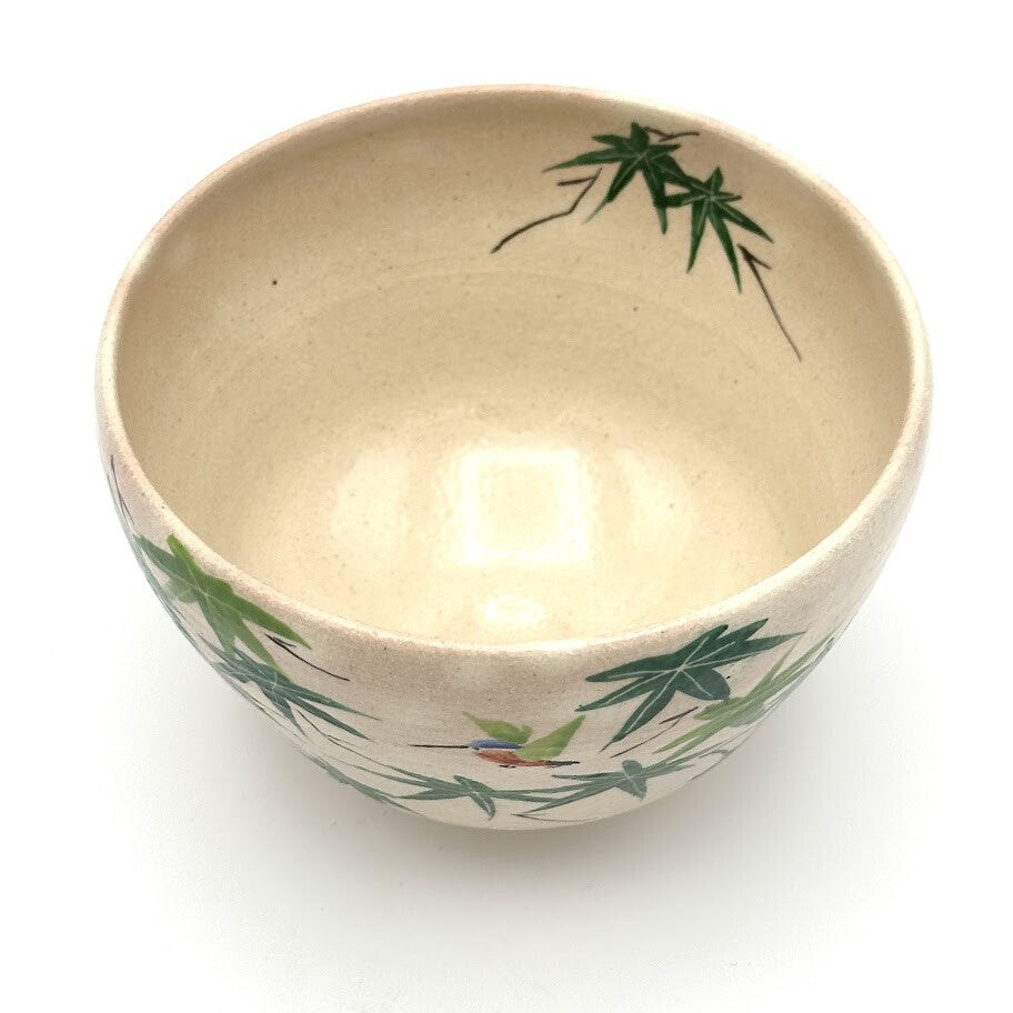 Top view of the kingfisher matcha bowl showing its warm beige interior and hand-painted green maple leaves extending along the rim.