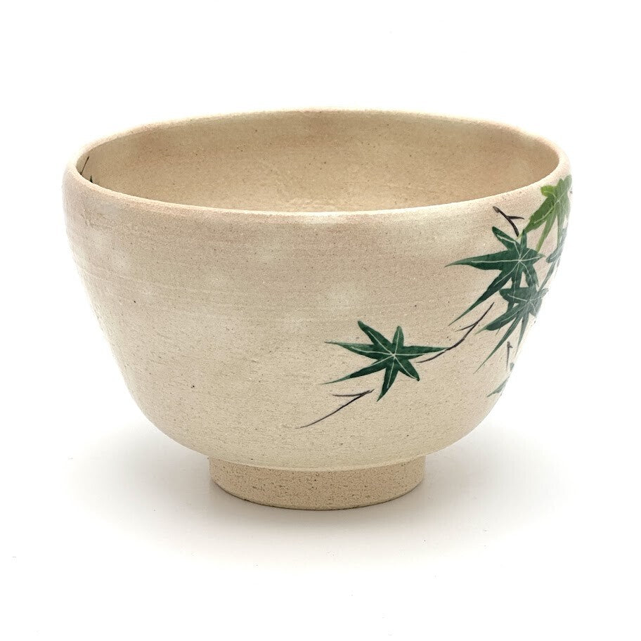 Right-side view of the Kiyomizu Ware matcha bowl with layered dark and light green maple leaves painted near the rim.