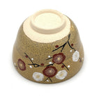 Underside view of the Kiyomizu-yaki Eda-Ume matcha bowl showing its ceramic foot and hand-painted white and red plum blossom decoration