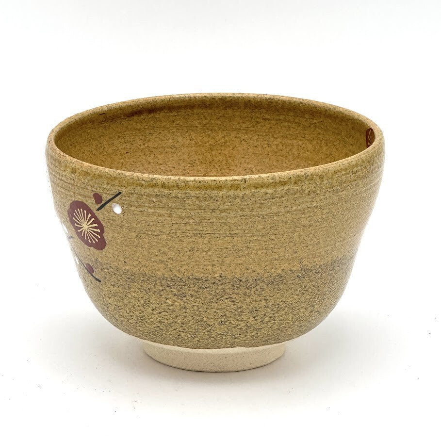 Angled view of the Kiyomizu-yaki Eda-Ume chawan showing its rounded profile, warm brown glaze, and partial hand-painted plum branch decoration