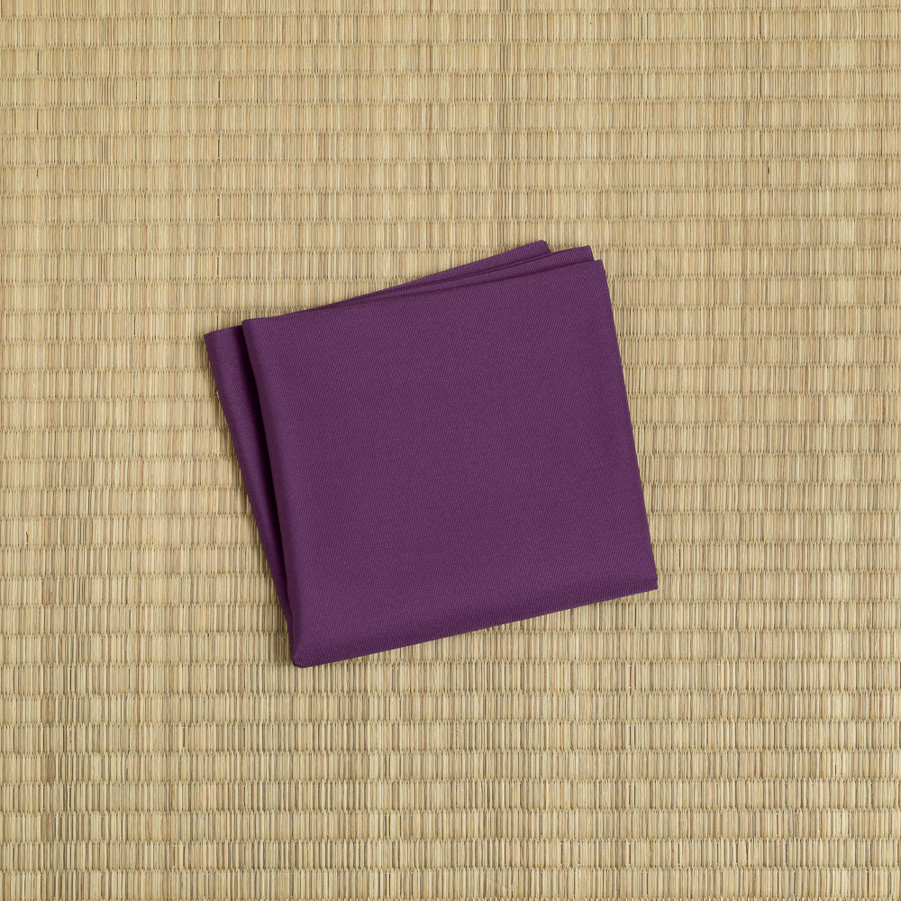 Folded plum color silk fukusa displayed on tatami mat for Japanese tea ceremony practice, handcrafted by Kitamura Tokusai.