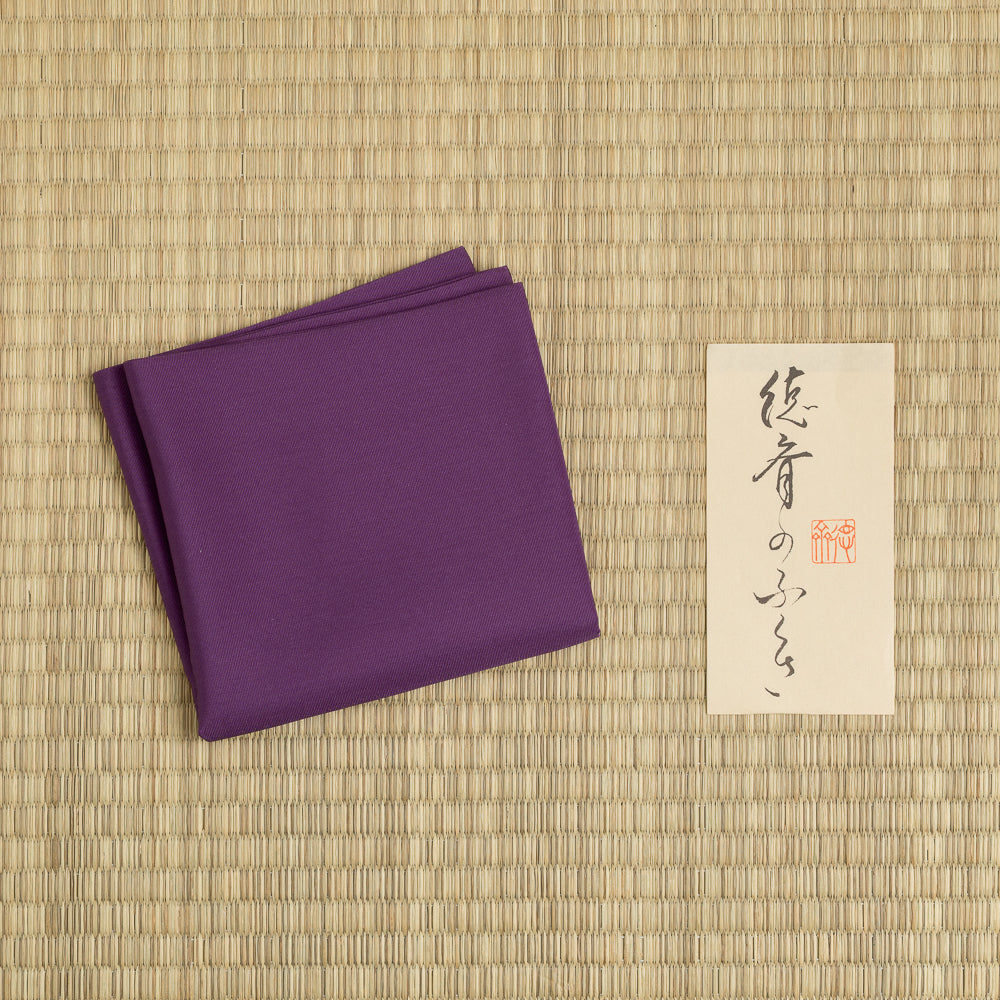 Plum silk fukusa displayed on tatami mat for Japanese tea ceremony practice, handcrafted by Kitamura Tokusai.