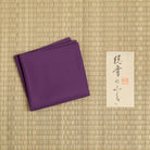 Plum silk fukusa displayed on tatami mat for Japanese tea ceremony practice, handcrafted by Kitamura Tokusai.