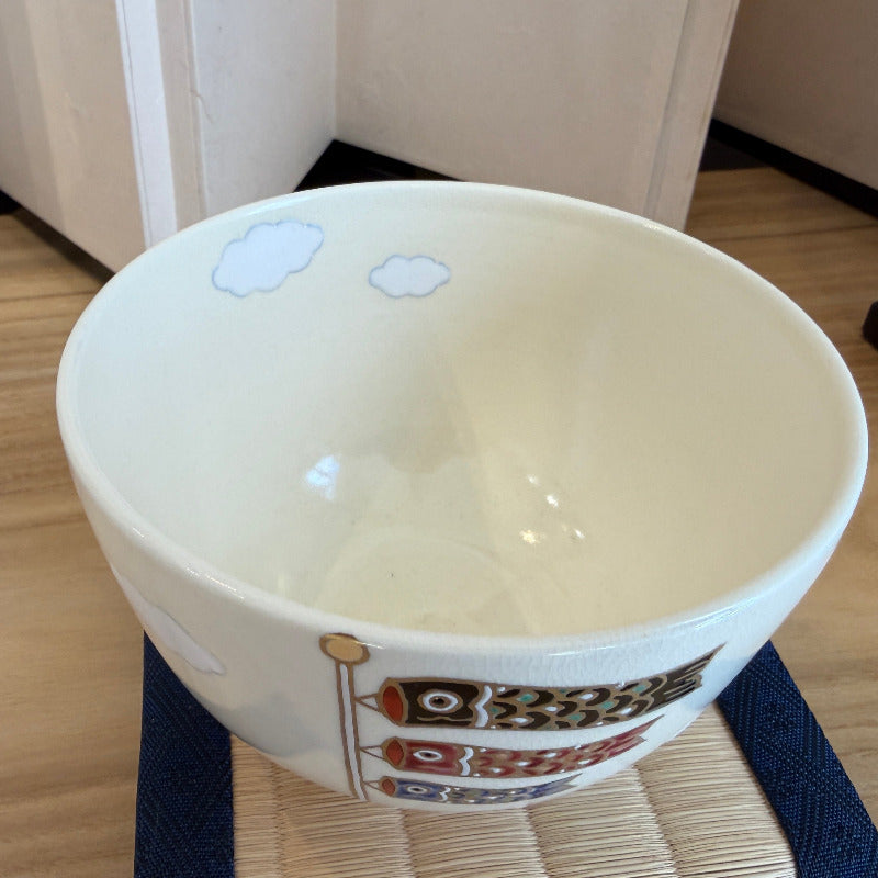 Top view of the koinobori matcha bowl showing its smooth ivory interior and part of the carp streamer design on the exterior rim.