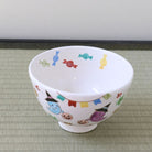 Top angled view of the Kyo Ware Halloween matcha bowl showing the white interior and colorful hand-painted ghost, pumpkin, and seasonal motifs around the bowl