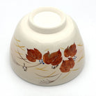 Underside view of the Kyo-yaki Aka Tsuta ni Suzume chawan showing its ceramic foot and hand-painted red ivy leaves and sparrow decoration
