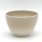 Reverse view of the Kyo-yaki Aka Tsuta ni Suzume matcha bowl highlighting its rounded form and smooth warm ivory glazed surface