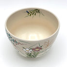 Top interior view of the Kyo-yaki Akikusa ni Usagi chawan showing its warm ivory glaze and hand-painted autumn grasses and floral decoration around the rim