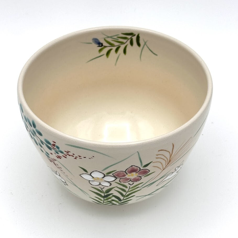 Top interior view of the Kyo-yaki Akikusa ni Usagi chawan showing its warm ivory glaze and hand-painted autumn grasses and floral decoration around the rim