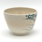 Side view of the hand-painted Kyo-yaki chawan showing a white rabbit with colorful autumn grasses and floral details against the ivory glaze