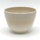Reverse view of the Kyo-yaki Akikusa ni Usagi matcha bowl highlighting its rounded form and smooth warm ivory glazed surface