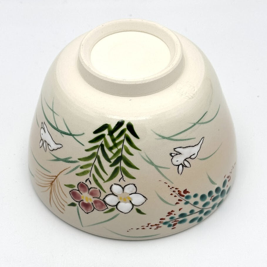 Underside view of the Kyo-yaki Akikusa ni Usagi matcha bowl showing its ceramic foot and hand-painted rabbits, autumn flowers, and grasses