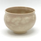 Reverse view of the Kyo-yaki Eda ni Suzume matcha bowl highlighting its rounded form and softly mottled warm beige glazed surface