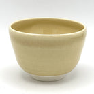 Reverse view of the Kyo-yaki Kaki ni Suzume matcha bowl highlighting its rounded form and softly textured warm beige glazed surface