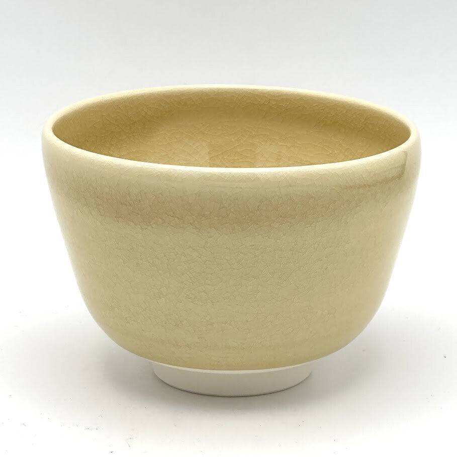 Reverse view of the Kyo-yaki Kaki ni Suzume matcha bowl highlighting its rounded form and softly textured warm beige glazed surface