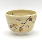 Hand-painted Kyo-yaki matcha bowl featuring the Kaki ni Suzume motif with ripe persimmons, autumn leaves, sparrows, and dark branches on a warm beige glaze