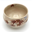 Top interior view of the Kyo-yaki Momiji Ryusui chawan showing its warm beige glaze and hand-painted autumn maple leaves continuing around the rim