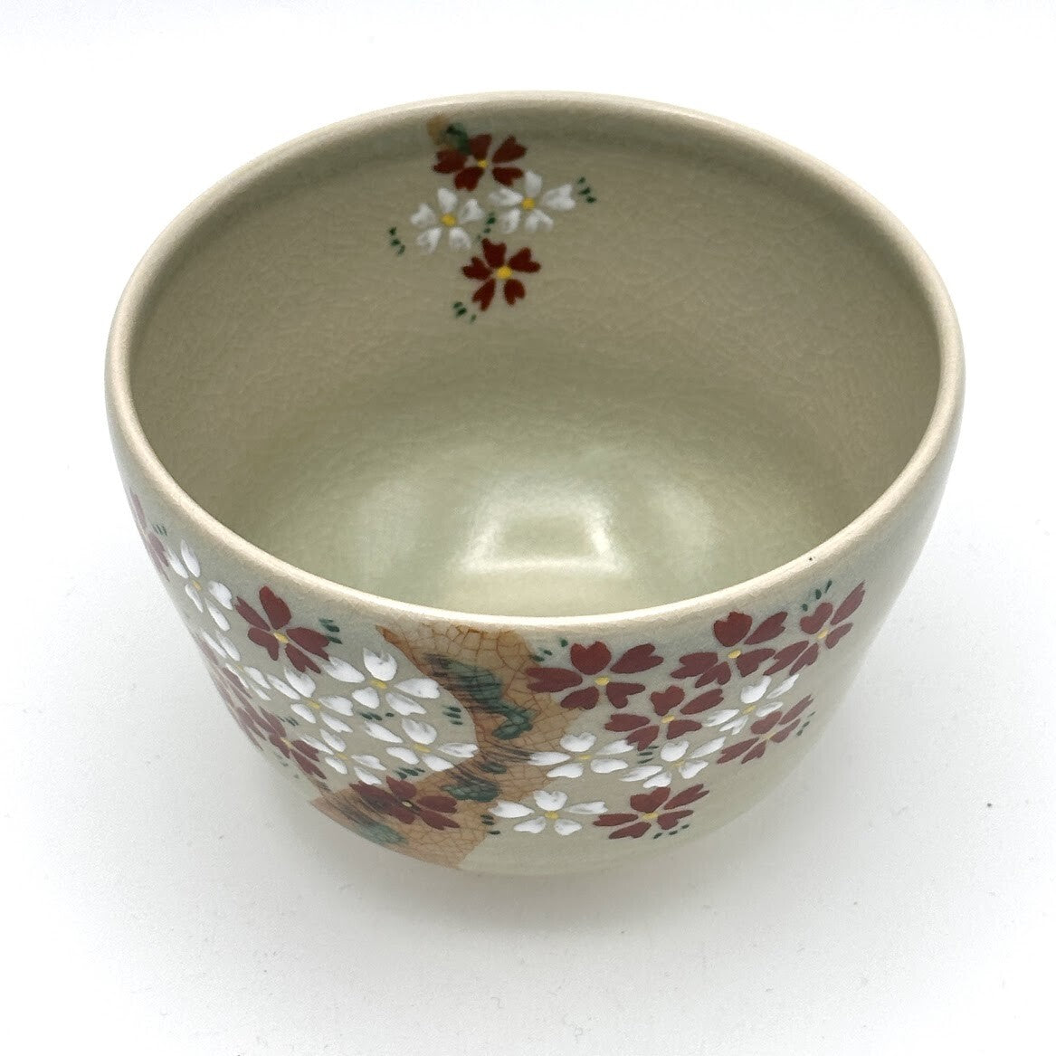 Top interior view of the Kyo-yaki Sakurazume chawan showing its soft beige glaze and pink and white cherry blossoms continuing around the inner rim