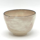 Reverse view of the Kyo-yaki yuzu chawan highlighting its rounded form and softly textured warm ivory glazed surface