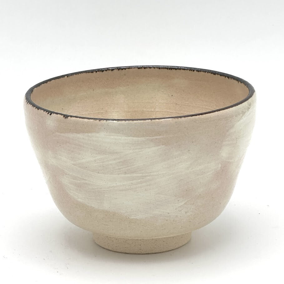 Reverse view of the Kyo-yaki yuzu chawan highlighting its rounded form and softly textured warm ivory glazed surface