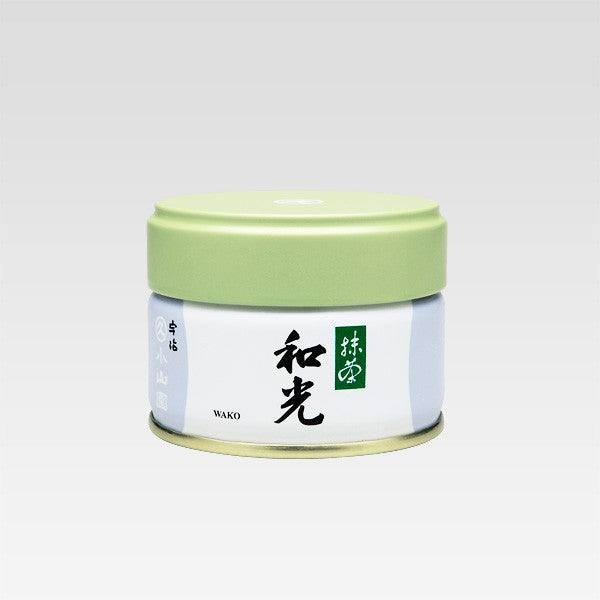 A can of Wako Matcha by Marukyu Koyamaen with green lid, white body, and label with black Japanese characters.