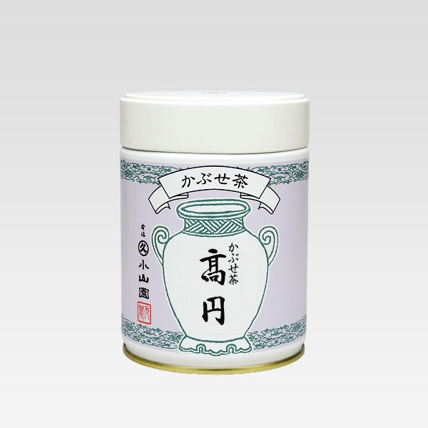 Cylindrical container with a white lid and green decorative elements on a light gray background