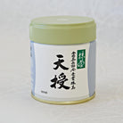 A canister of Tenju Ceremonial Grade Matcha tea, with a label featuring Japanese characters and a green lid.