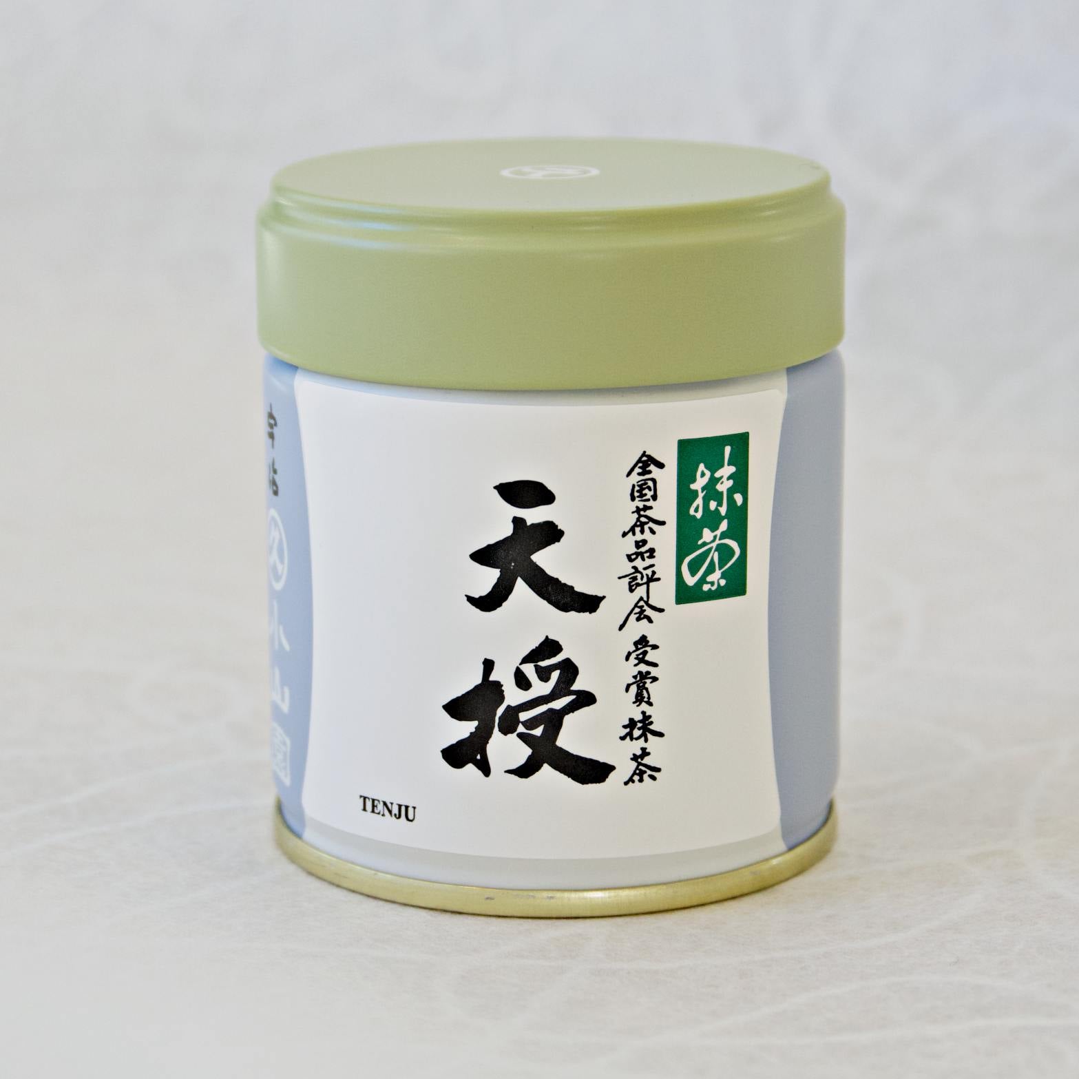 A canister of Tenju Ceremonial Grade Matcha tea, with a label featuring Japanese characters and a green lid.