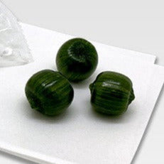 Matcha candies on a white tray with a white background