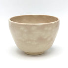 Reverse view of the Matsu Kyo Ware chawan showing its softly textured beige glaze and rounded ceramic form