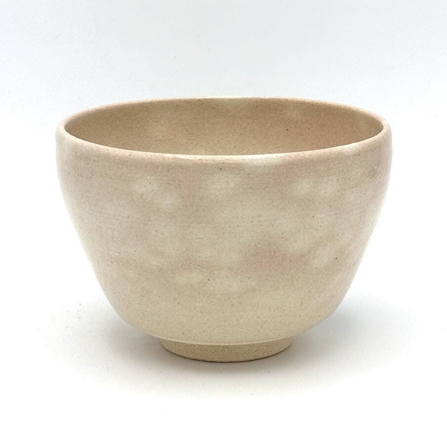Reverse view of the Matsu Kyo Ware chawan showing its softly textured beige glaze and rounded ceramic form
