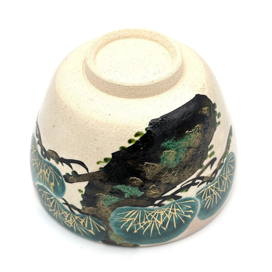 Underside view of the Matsu Kyo Ware chawan showing its ceramic foot and hand-painted pine decoration
