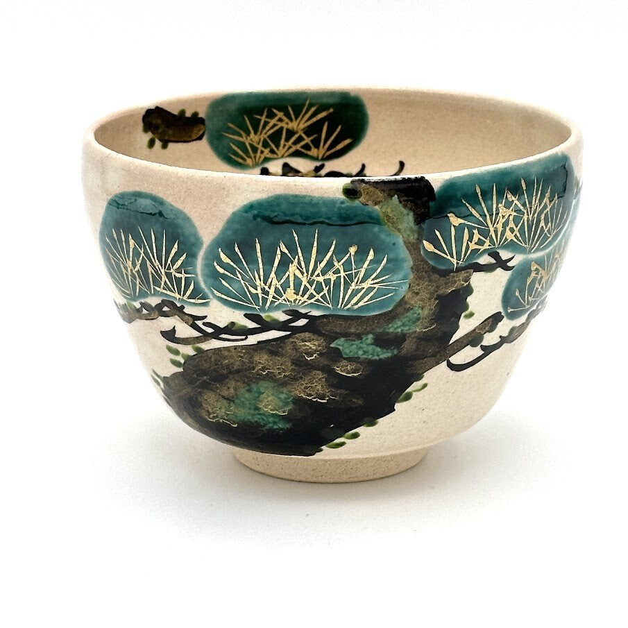 Hand-painted Kyo Ware matcha bowl featuring a traditional Matsu pine motif with deep green foliage and detailed pine needles