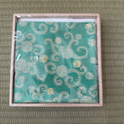 Turquoise Matsuman Shoha Zabosai Konomi silk kobukusa by Yuko Tsuchida displayed in its presentation box on tatami.
