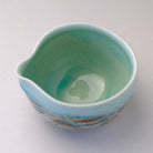 Top view of the katakuchi matcha bowl showing its glossy mint blue interior and pointed pouring spout.